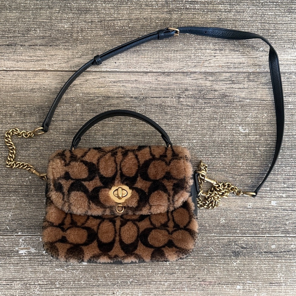 Coach x Jennifer Lopez Sherpa black and tab all over print crossbody purse.